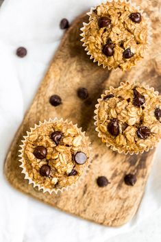 three oatmeal chocolate chip muffins on a cutting board