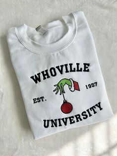 "Whoville Christmas Holiday Embroidered Sweatshirt. If you want a different thread color please message us first and put your color change request in the \"Buyers Notes\" during checkout. Material: 100% Cotton Ribbed Neckline, hem and cuffs Fit: Shirts are UNISEX MEN: Order Regular Size WOMAN: Order 1 Size down for tighter fit Care: Wash with like colors using warm water. Tumble dry medium or low." Grinch Sayings, Whoville Shirt, Whoville Sweatshirt, Nike Iron On Grinch Sweatshirts, Grinch Christmas Sweater Shirt, The Grinch Sweatshirt, Whoville University Sweatshirt, Christmas Sweatshirt Ideas, Grinch Quotes