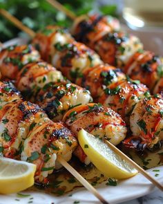 a plate with shrimp skewers and lemon wedges