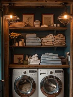 a washer and dryer in a room next to some shelves filled with towels