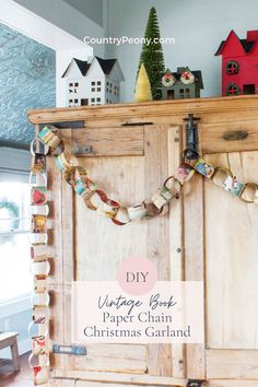 a wooden cabinet with paper chains hanging from it's sides and the words diy vintage book page chain christmas garland on top