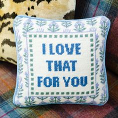 a cross stitch pillow with the words i love that for you written in blue on it