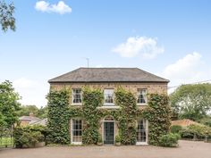 an old brick house covered in ivy