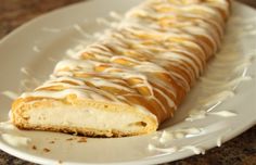 a white plate topped with a pastry covered in icing