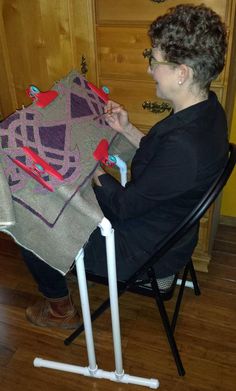 a woman sitting in a chair with a piece of fabric on it