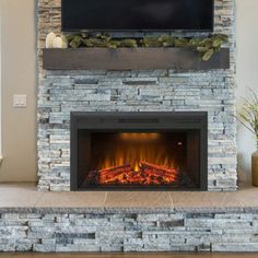 a fireplace with a flat screen tv mounted above it's mantle and fire place