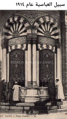 an old black and white photo of people standing in front of a building with columns