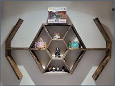 the shelves are made out of wood and have various items on them in hexagonal shapes