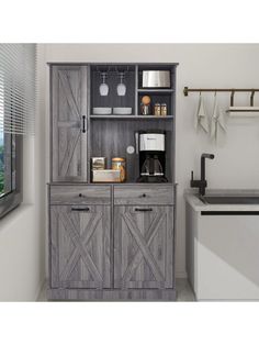 a kitchen cabinet with sliding doors and drawers in grey wood, next to a sink