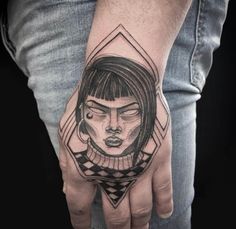 a woman's hand with a tattoo on it