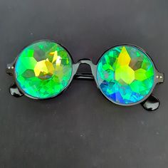 Black Kaleidoscope Sunglasses For Festivals And Raves. Real Glass Crystal Lenses Provide The Most Perfect, Psychedelic Incredible Kaleidoscope Effect Style: Modern Hippy Condition: New, Never Worn. Black Glass Sunglasses For Festival, Rave Party Sunglasses With Mirrored Lenses, Rave Festival Sunglasses With Tinted Lenses, Rave Style Festival Sunglasses With Tinted Lenses, Rave Festival Sunglasses With Mirrored Lenses, Black Retro Sunglasses For Festival, Retro Black Sunglasses For Festival, Black Sunglasses With Gradient Lenses For Festival, Rave Sunglasses With Mirrored Lenses And Adjustable Fit