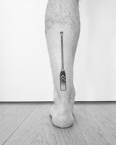 a black and white photo of a person's foot with a toothbrush on it