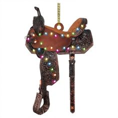 a christmas ornament shaped like a cowboy's saddle with lights on it