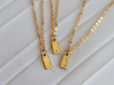 Personalize your necklace and create a meaningful gift with our Initial Tag Necklace. Ideal for everyday wear and layering, this stunning necklace is the perfect gift for yourself, loved ones, bridesmaids, or weddings. Each item is meticulously hand-stamped and personalized, offering a variety of meanings and love. Crafted with tarnish-resistant stainless steel, our materials ensure long-lasting beauty. Customize the charm with one to three characters (letters or numbers) to make it uniquely yours. The necklace hangs elegantly from a 16-inch chain with a 2-inch extender. It comes ready to be gifted on a jewelry card. Materials: - Hypoallergenic stainless steel chain  - Stamped stainless steel tag - Chain length: 16 inch + 2  inch extender Personalization:  You have the option to personaliz Minimalist Pendant Charm Necklace For Best Friend, Minimalist Initial Pendant Charm Necklace For Gift, Minimalist Initial Pendant Charm Necklace As Gift, Minimalist Charm Necklace With Delicate Chain For Best Friend, Minimalist Delicate Chain Charm Necklace For Best Friend, Simple Rectangular Necklace For Gift, Simple Initial Pendant Charm Necklace For Gift, Dainty Rectangular Initial Necklace For Gift, Delicate Chain Initial Necklace For Mother's Day