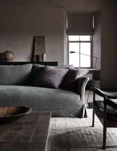 a living room filled with furniture next to a window