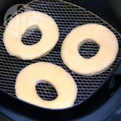 two donuts are being fried in an air fryer with white rings on them