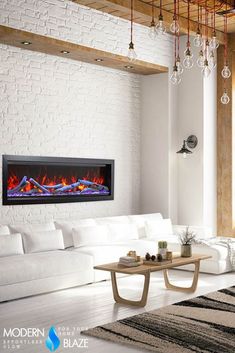 a living room with a large white couch and a fire place in the middle of it