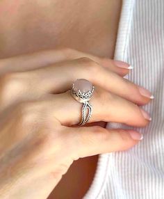 Looking for a gift for that special woman in your life? This exquisite silver filigree art women's cocktail ring is a perfect choice. With its intricate details and stunning face-up design, it's sure to make an impression. This ring features a cabochon round-cut Rose Quartz gemstone, which is 10mm in size and has a 0.47" / 12.00mm width face size, making it an absolute stunner when worn. This stunning piece comes with a velvet pouch, silver polish cloth, and a luxurious gift box, making it an id Round Filigree Ring With Gemstone, Silver Cocktail, Silver Polish, Art Women, Box Making, Rose Quartz Gemstone, Peridot Gemstone, Sterling Silver Filigree, Gifts For Your Girlfriend