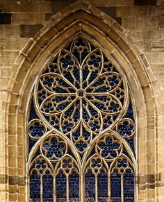 an ornate stained glass window on the side of a building