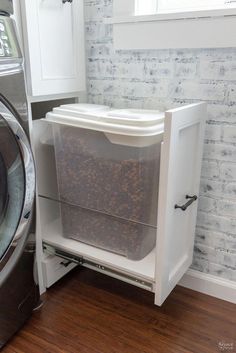 a washer and dryer sitting next to each other in front of a brick wall