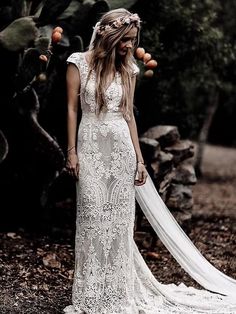 a woman in a wedding dress standing next to a motorcycle