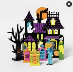 a paper cut out of a house with halloween decorations