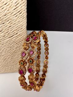 Traditional Bangles comes as a pairColor : Matte Size : Size : 2.4Stones : AD Red Green Stone Stone Bangles Gold, Antique Necklace Victorian, Traditional Bangles, Stone Bangles, Lehenga Red, Bangles Gold, Real Pearl Necklace, Matte Size, Ethnic Necklaces