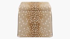 an animal print stool with white spots on the top and brown fabric seat padding