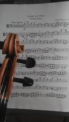 an old violin is sitting on top of sheet music