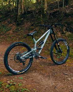 a mountain bike parked on a trail in the woods