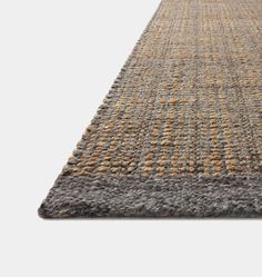 an area rug with grey, yellow and brown colors on the bottom half of it