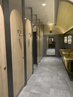 a row of wooden stalls in a public restroom