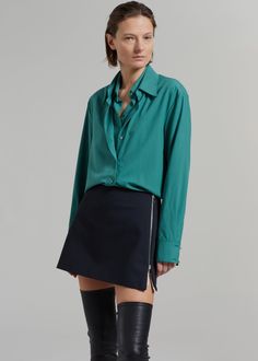 Color: Deep Teal Lightweight silky shirting fabric Relaxed fit Double layer shirt Attached shirt panel at front Double pointed collar Curved hem Button cuffs Double front button closure Unlined 100% Lyocell Hand Wash or Dry Clean Imported Silk Office Shirt With Fold Down Collar, Silk Shirt With Lapel Collar For Work, Silk Workwear Shirt With Placket, Green Silk Button-up Blouse, Semi-formal Blouse With Lapel Collar, Semi-formal Blouse With Lapel Collar And Placket, Versatile Workwear Shirt With Shirttail Hem, Chic Semi-formal Shirt With Placket, Chic Shirt With Concealed Placket And Fold Down Collar