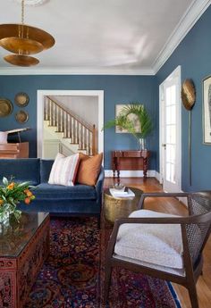 a living room with blue walls and furniture