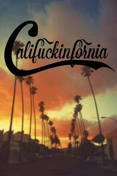 the word california is written in front of palm trees and buildings at sunset or dawn