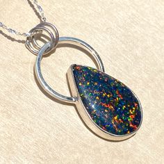 Kyocera Opal handcrafted into a cabochon and placed in a customized sterling silver bezel setting. Includes an 18 inch, solid sterling silver 1.2mm serpentine chain. Pendant measures 0.8" x 1.5" and the cabochon is approximately 16 x 24mm. Polished Snake Chain Jewelry As Gift, Polished Snake Chain Jewelry For Gifts, Sterling Silver Snake Chain Necklace With Polished Finish, Nickel-free Sterling Silver Snake Chain Necklace, Sterling Silver Large Round Pendant Jewelry, Nickel-free Sterling Silver Oval Pendant Necklace, Nickel-free Sterling Silver Teardrop Pendant Necklace, Nickel Free Sterling Silver Teardrop Pendant Necklace, Nickel-free Oval Opal Jewelry