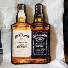 two bottles of jack daniels whiskey sitting next to each other