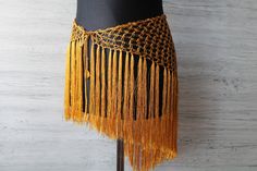 Hip scarf belt for belly dance crochet off viscose yarn in deep gold color *super shimmery and pleasant to the touch *Has a long adjustable cord  *Size- length with fringe- 21,6"(55cm) Width of the triangle part- 31,4" (80cm)  length of the cord- 47.2"(120cm) *Custom colours and sizes available,just tell me your measurements *Care instructions- hand wash in warm water Other hip scarves you can see here: https://www.etsy.com/shop/LacyStories?ref=seller-platform-mcnav&section_id=27353438 Dance Crochet, Belly Dance Hip Scarf, Belt Scarf, Fringe Belt, Feather Fashion, Hip Scarf, Hip Scarves, Fringed Belt, Crochet Fringe