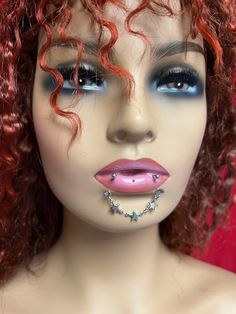 a mannequin with red hair and piercings on it's face is shown