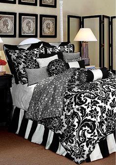 black and white bedding with pictures on the wall