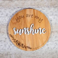 a wooden sign that says you are my sunshine on the side of a white wall