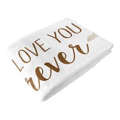 a white and brown pillow with the words love you never written in gold on it