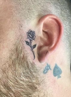 a man with a rose tattoo on his ear