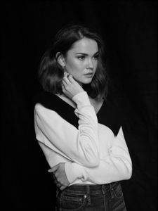 a black and white photo of a woman with her arms crossed