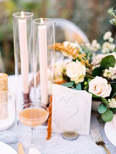 the table is set with candles and flowers