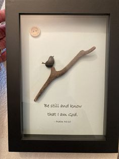 a framed picture with a quote and a bird on a branch that says be still and know that i am god