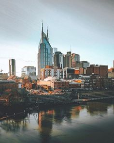 the city skyline is reflected in the water