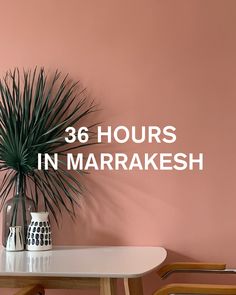 a white table with a plant on top and the words, 38 hours in marrakesh