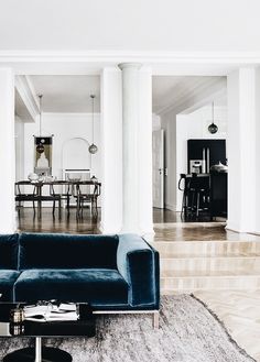 a living room filled with furniture and white walls