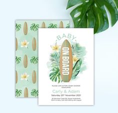 a baby shower card with a surfboard and tropical leaves on it, next to a plant